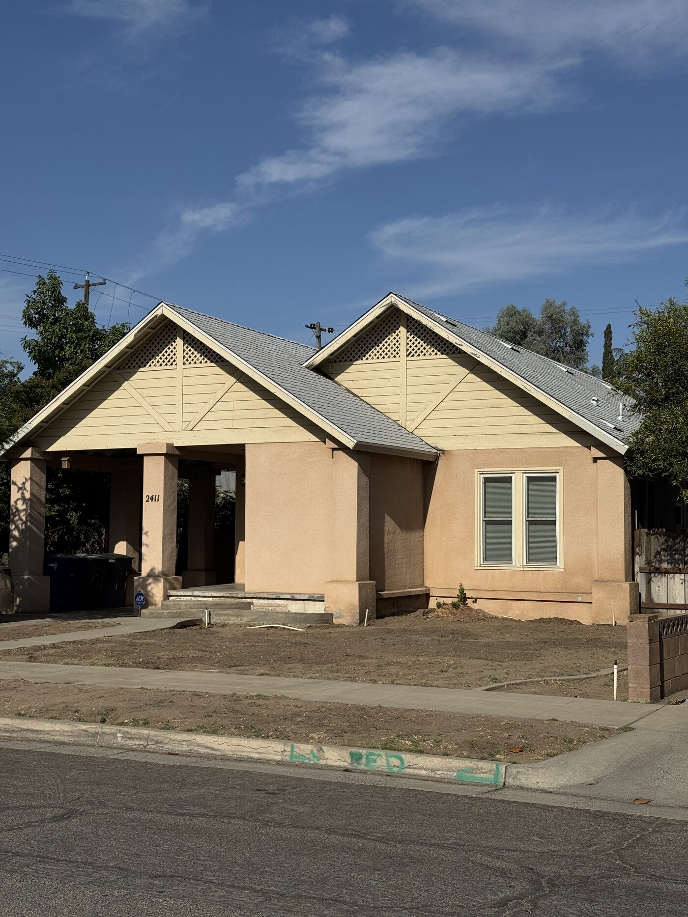 After: the same home with its finished light gray architectural shingle roof