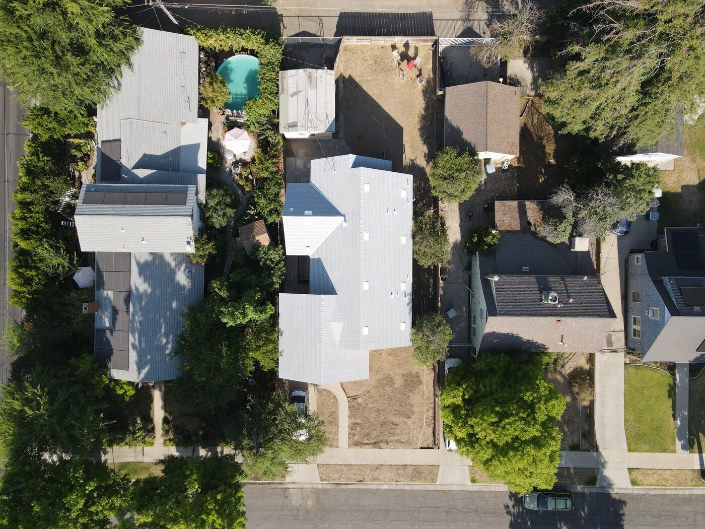 Top-down aerial of the completed light gray shingle roof