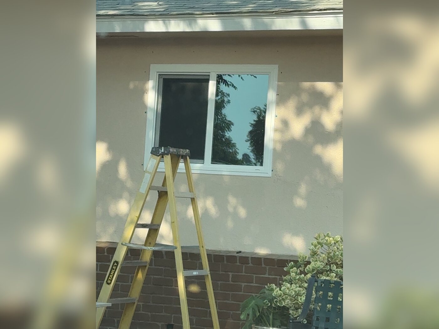Window installation in progress on a Fresno, CA home