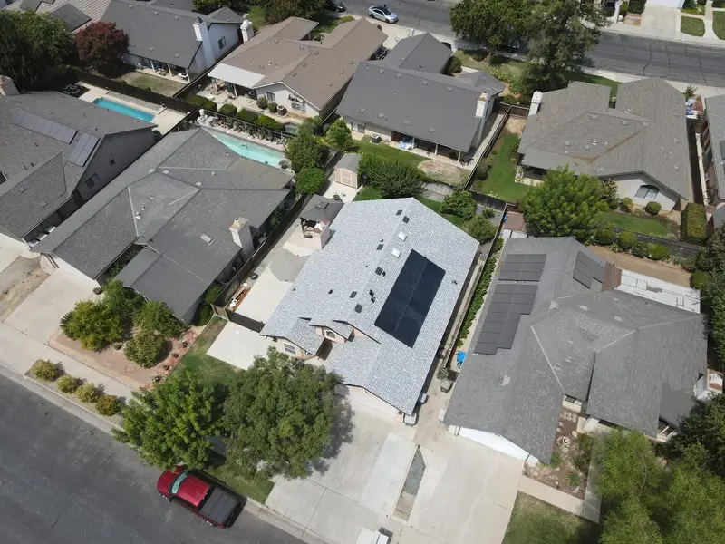 Completed asphalt shingle roof replacement on a home in Clovis, CA by Smart Home Improvements