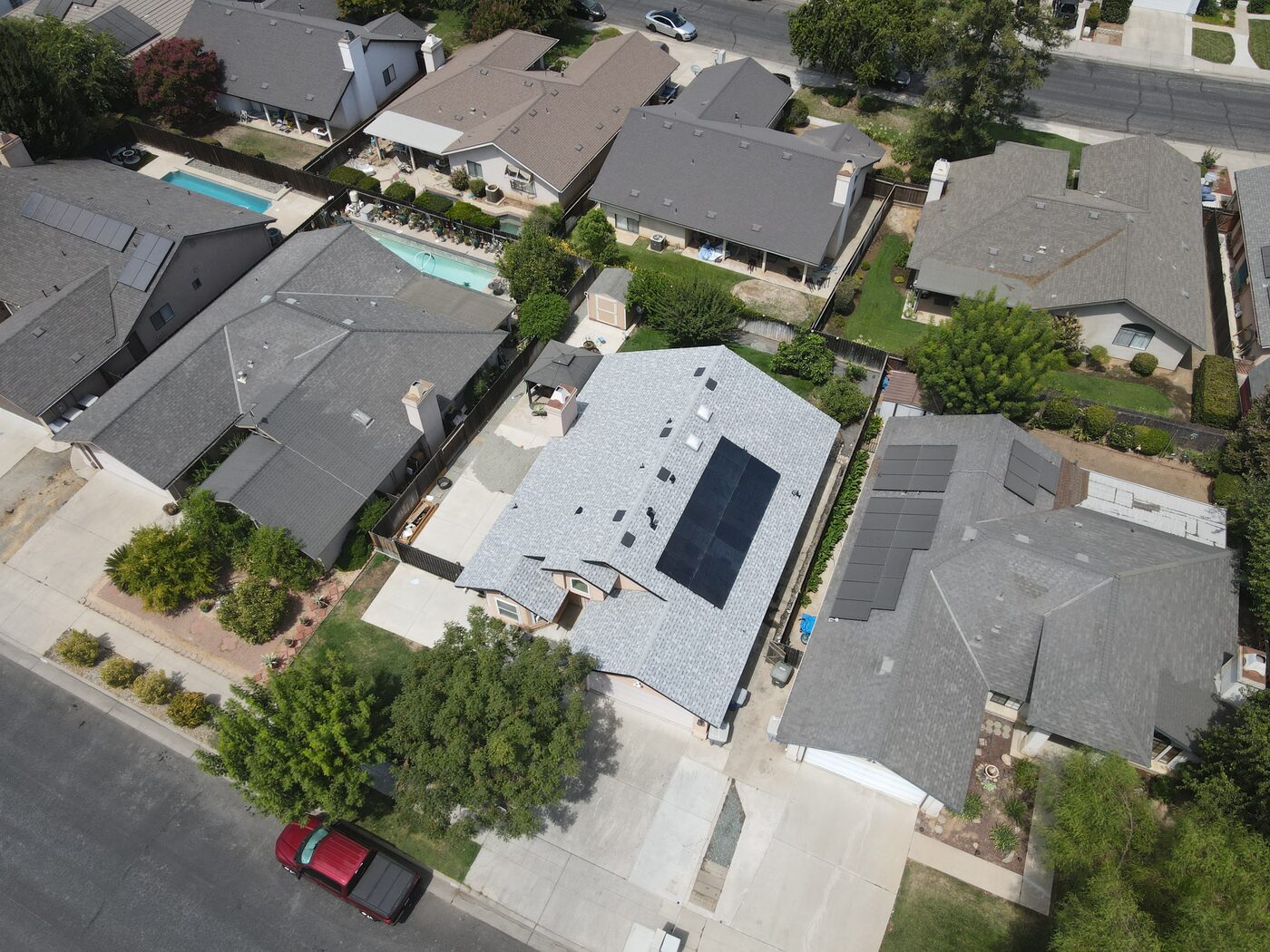 Completed asphalt shingle roof replacement on a home in Clovis, CA by Smart Home Improvements