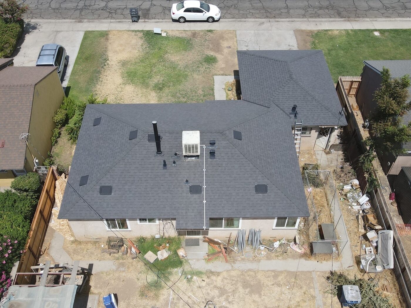 Roof repair work in progress on a Fresno, CA home showing fresh underlayment