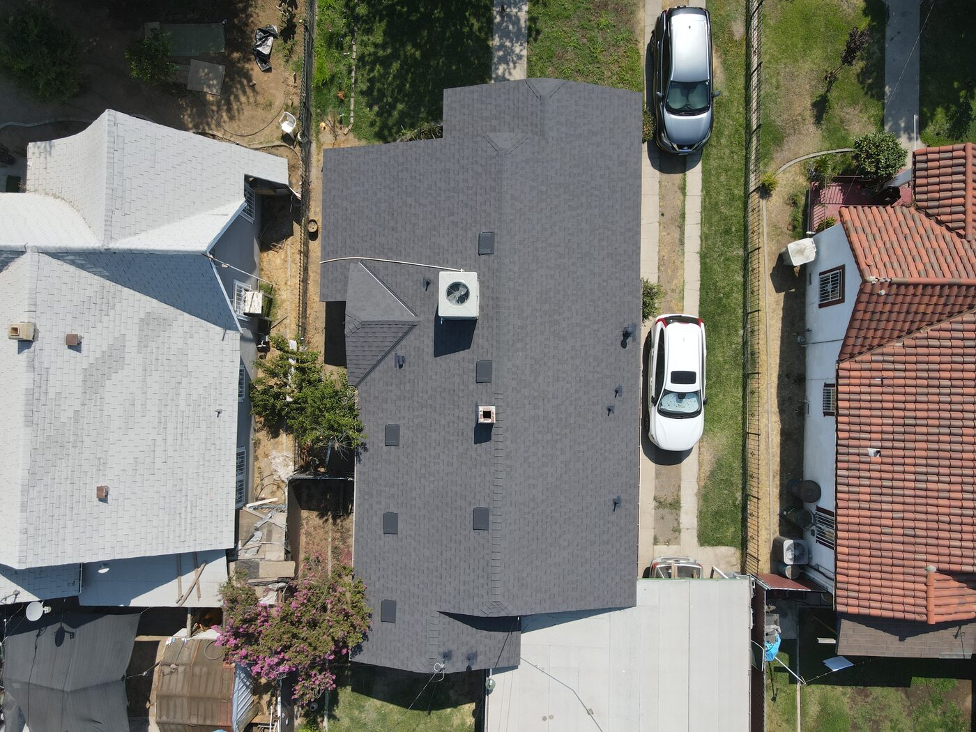 Newly replaced gray shingle roof on a Fresno, CA home, aerial view