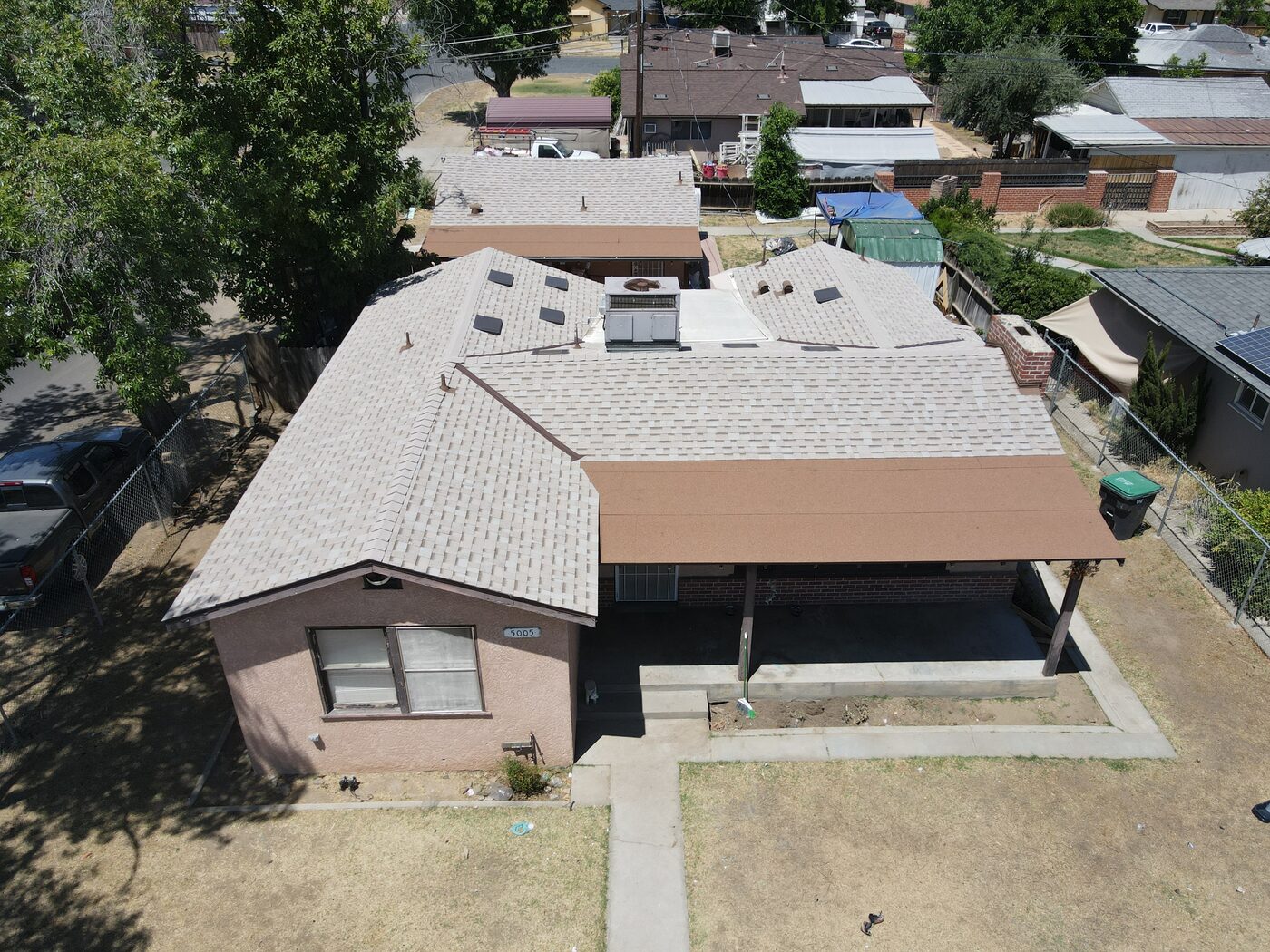 Finished charcoal architectural shingle roof on a Fresno, CA home, aerial view