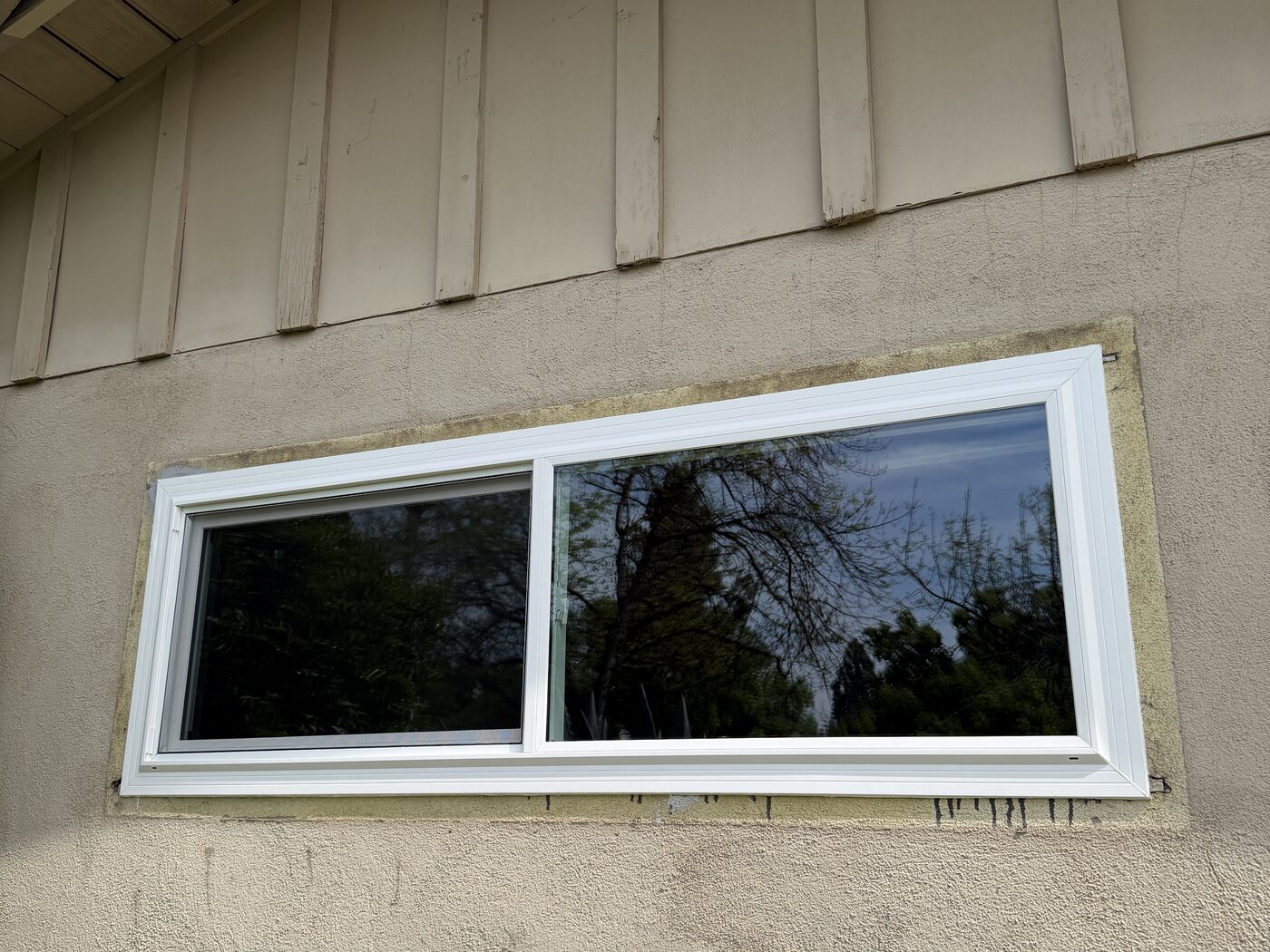 Newly installed white vinyl window on a Fresno, CA home exterior